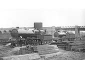 An unidentified L&Y 4-6-0 locomotive and a LNWR 4-6-0 locomotives take it in turn to pick up water