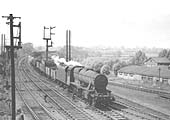 An unknown ex-LMS 8F 2-8-0 locomotive is heading a train of mineral wagons off the Leicester to Rugby branch line
