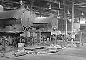 Inside Rugby's Repair Shops showing two ex-LNWR 0-8-0 locomotives and an ex-LMS 4-4-0 Compound locomotive