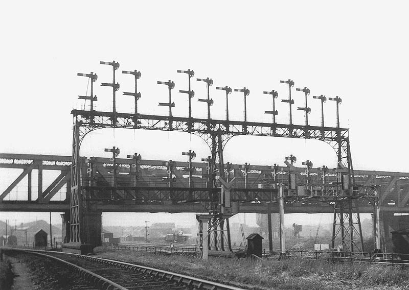 Another view of Rugby's famous signal gantry nicknamed the 'Rugby bedstead' with the GC bridge in the background
