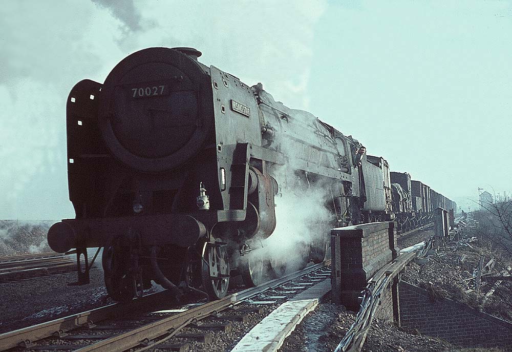 British Railways 4-6-2 7MT Britannia Class No 70027 'Rising Star' takes the Coventry line out of Rugby passing Rugby No 7 Signal Cabin on 26th February 1962