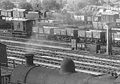 Close up showing an ex-LMS 4-6-0 5XP locomotive arriving in the up marshalling yard sidings with a train of box vans