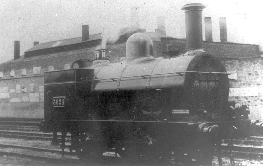 LNWR 0-4-0ST No 3024 pauses from its pilot duties along side the Midland Railway shed at Rugby circa 1900