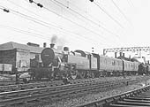 Ex-LMS 4MT 2-6-4T No 42400 is running wrong road at the head of a Class C parcels working