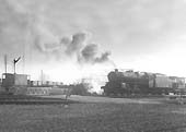 An unidentified ex-LMS 8F 2-8-0 locomotive is seen in the process of making up an engineers' work train