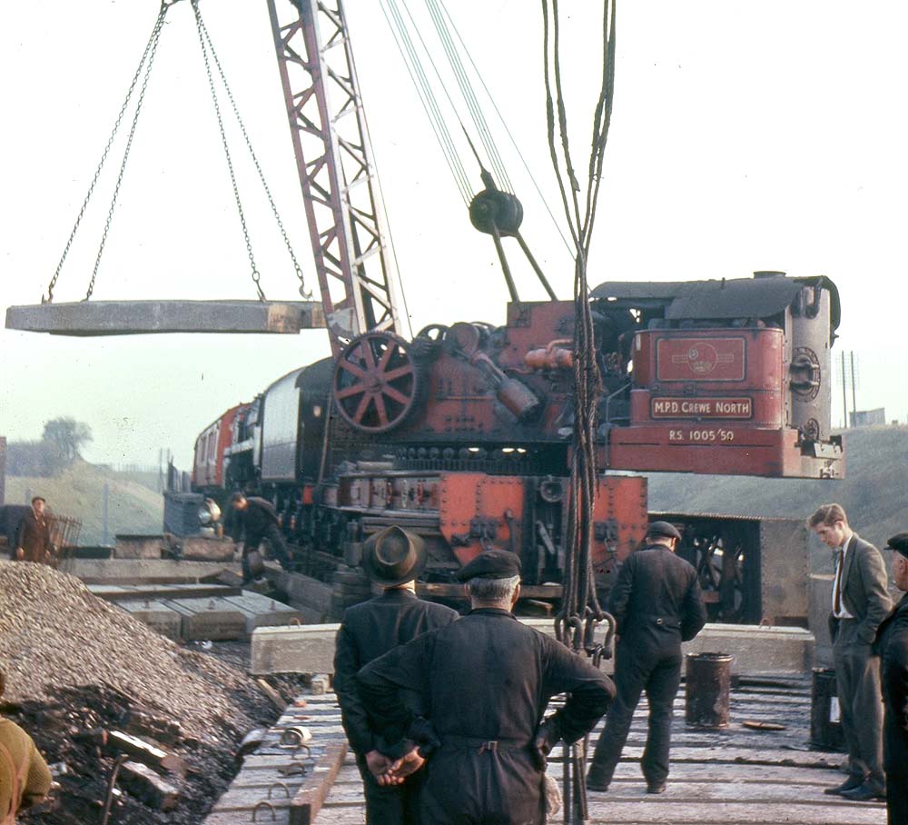 Crewe North shed's Railway Steam Breakdown Crane is seen lifting a number of precast concrete beams on to the deck of the rebuilt Clifton Road Junction railway bridge