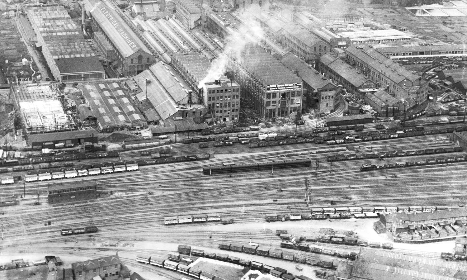 A 1920 aerial view of the immediate northern approach to Rugby station with No 5 Signal Cabin on the left, the entrance to the goods yard lower right and and BTH in the background