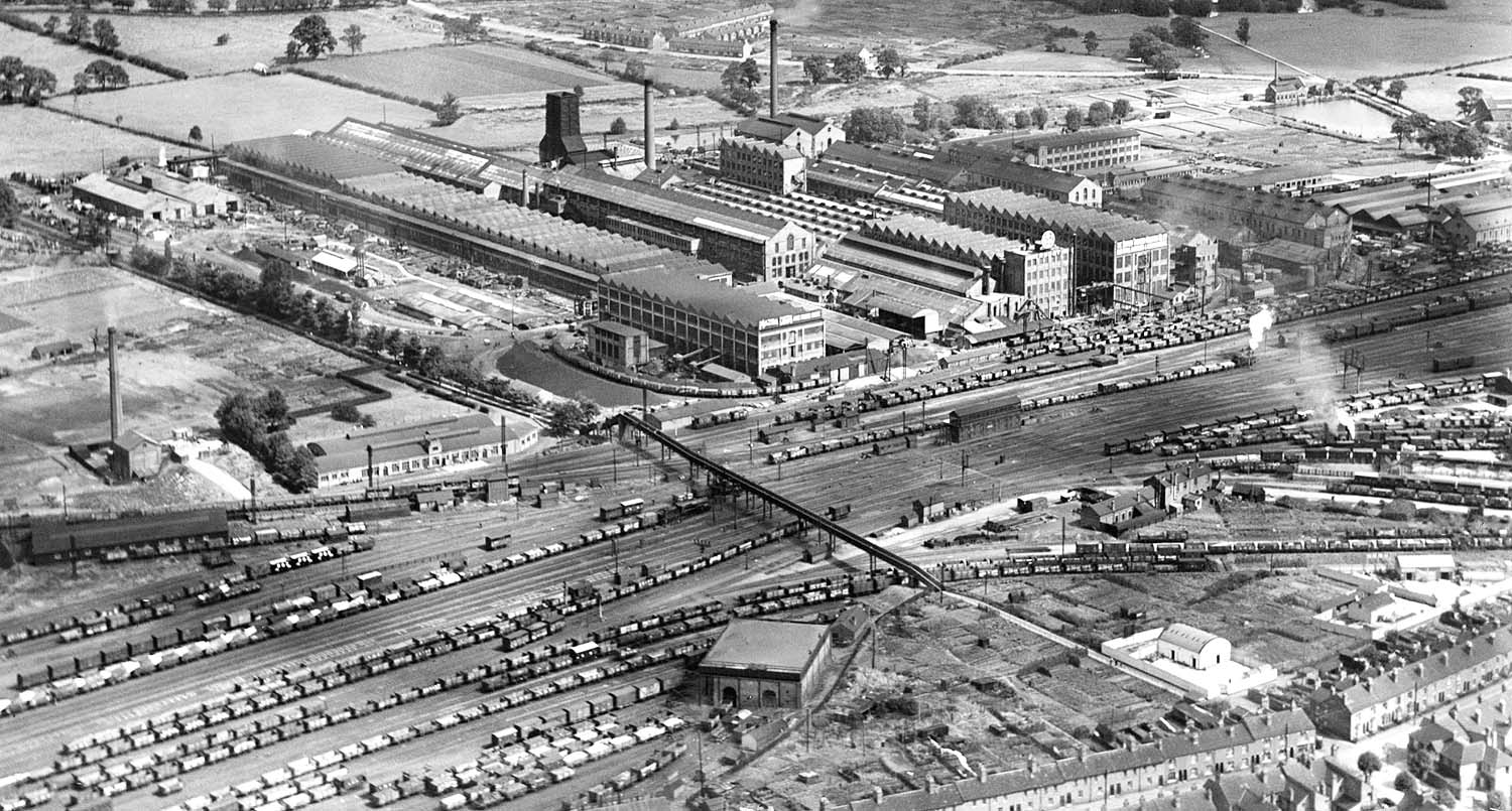 A panoramic aerial view of the approach into Rugby of the Leicester line, the exchange sidings and the goods yard in 1930