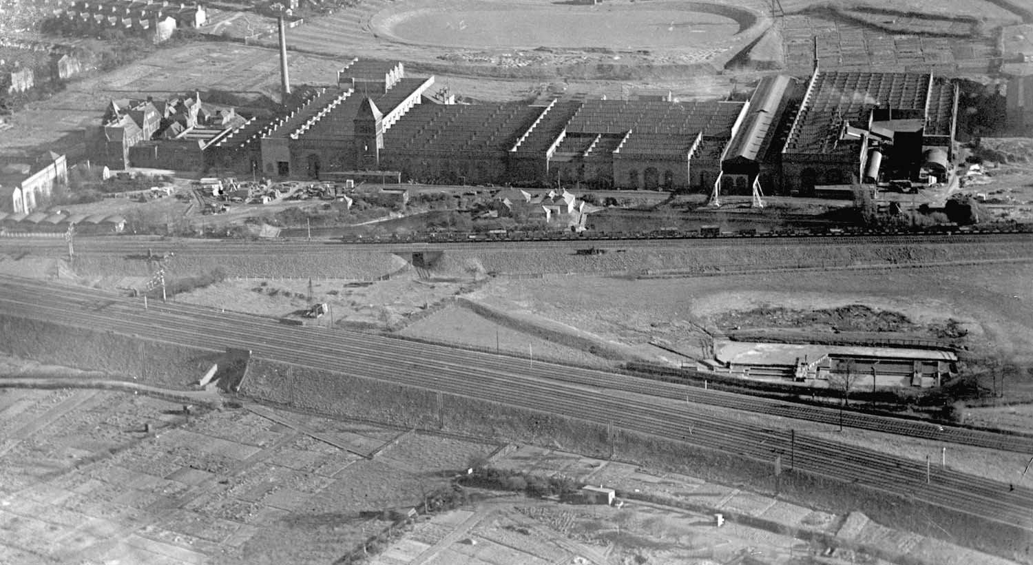 A 1930 aerial view of the junction between the Trent Valley lines and the lines to Coventry with the Rugby to Leamington line in front of Willans & Robertson's Victoria works