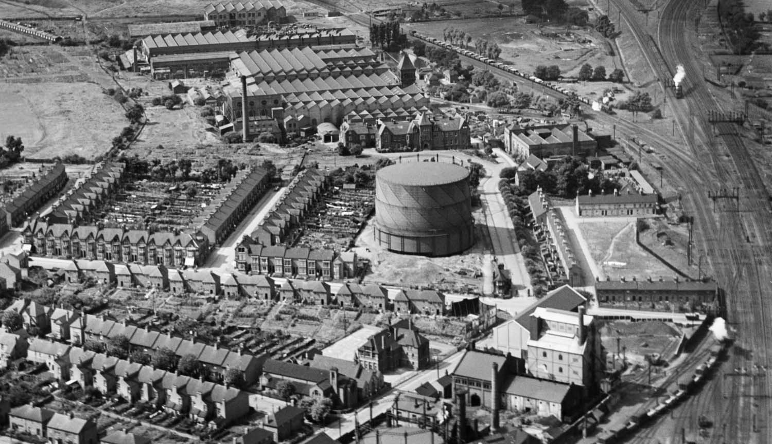 An Easterly 1930 aerial view of English Electric Works with Old Station Square housing adjacent to the turntable
