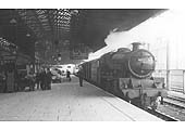 Ex-LMS 4-6-0 Jubilee class No 45722 'Defence' stands in the station on an up train at platform 1