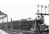 Ex-LMS 4-6-0 Jubilee class No 45704 'Leviathan' stands on the avoiding line at the head of an up express