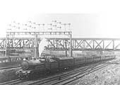 An unidentified ex-LNWR 4-6-0 Prince of Wales class is seen at the head of a down express as it passes under the GC bridge