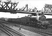 LNWR 2-8-0 E class No 2563 is seen passing under the GC Birdcage bridge whilst at the head of an up goods train