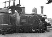 LNWR 2-2-2 Problem class No 837 'Faerie Queen' stands at the head of an up train whilst the driver oils the bearings