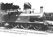 LNWR 2-4-2T 5 ft 6 inch tank engine No 1754 stands at the head of a local passenger service to Northampton