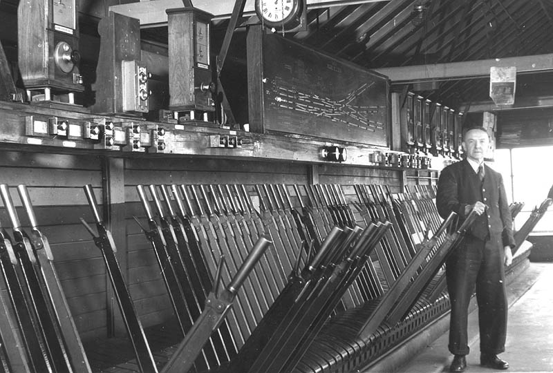 An internal view of Rugby's No 7 signal cabin with one of the 'bobbies' standing by its large lever frame