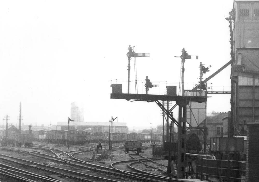 Close up view showing the goods yard, full of mainly covered vans, together with LNWR somersault signals