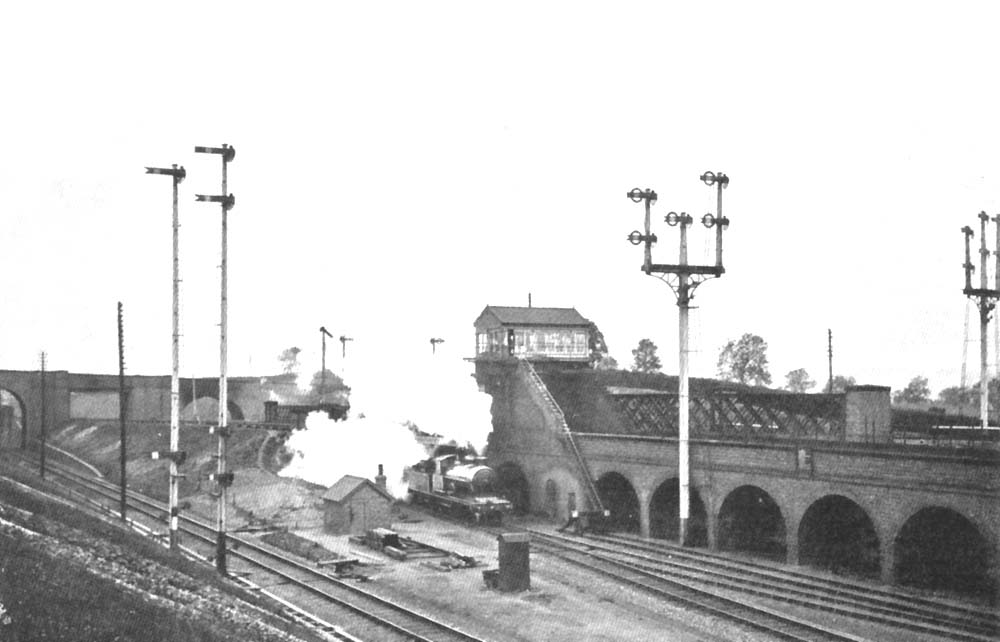 Postcard view of Clifton Road signal box from another angle as a LNWR 4-4-0 storms underneath on an up express