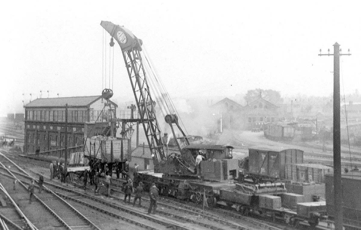 Rugby's brakedown train is seen rerailing mineral wagons alongside Rugby No 5 signal box with the goods yard in the distance