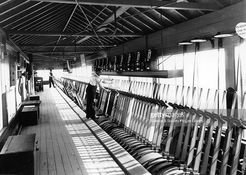 The interior of Rugby's No 1 Signal Box with two signalmen in attendance - each being responsible for a section of levers etc