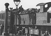 The driver of No 25656 stands at the base of the water column ready to turn the water on when his mate has 'placed the bag in the hole'