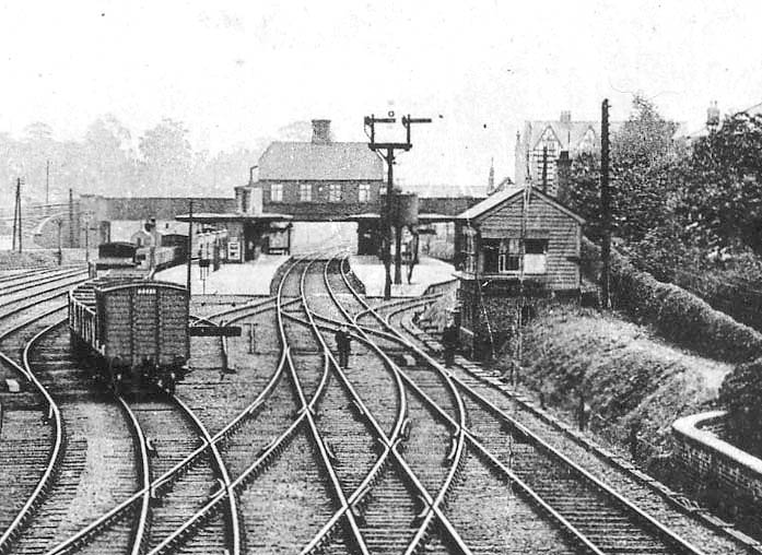 Close up showing Stechford station's two island platforms with the main station building being located above the railway