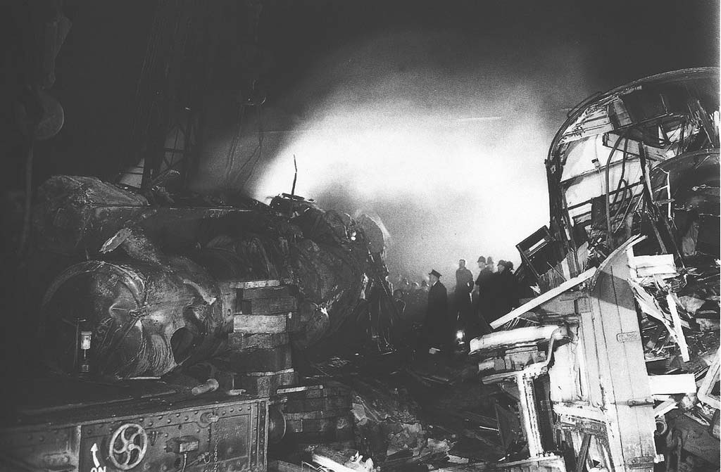 A night time view of the wreck of ex-LMS 5MT 4-6-0 No 45274 which is lying on its side next to the remains of one of the carriages