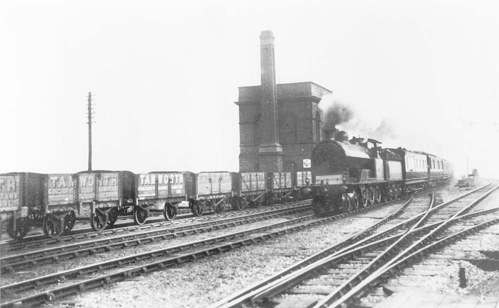 LNWR 4-6-0 Experiment class No 2627 'President Lincoln' is seen at the head of the 10 05 am Euston to Perth express as it passes a line of Tamworth Colliery wagons