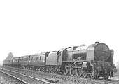 LMS 6P 4-6-0 Royal Scot class No 6153 'The Royal Dragoon' is seen at the head of a six-coach express service near Newbold Troughs