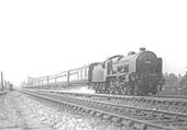 LMS 5XP 4-6-0 Patriot class No 5516 'The Bedfordshire and Hertfordshire Regiment' picks up water as it hurries past on an up Euston express
