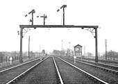 View of a crossover junction, signal gantry and signal box on the Trent Valley line north of Rugby station circa 1933