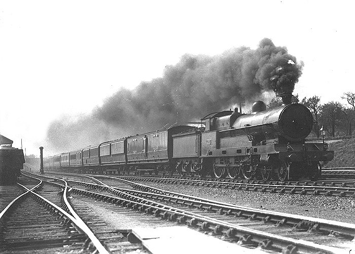 An unidentified LNWR 4-6-0 Claughton class locomotive is seen in full flight passing opposite Brinklow goods shed