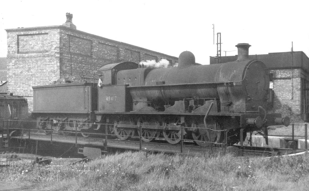 A very dirty ex-LNWR 7F 0-8-0 'G2', No 49417, is seen having being turned 270° on Milverton shed's single road turntable