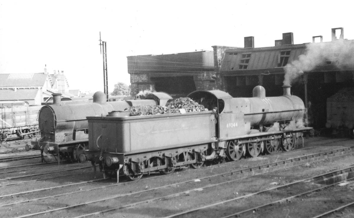 Ex-LNWR 7F 0-8-0 'G2a' No 49244 is seen in company with an unidentified class mate as both raise steam for their next trips in June 1951