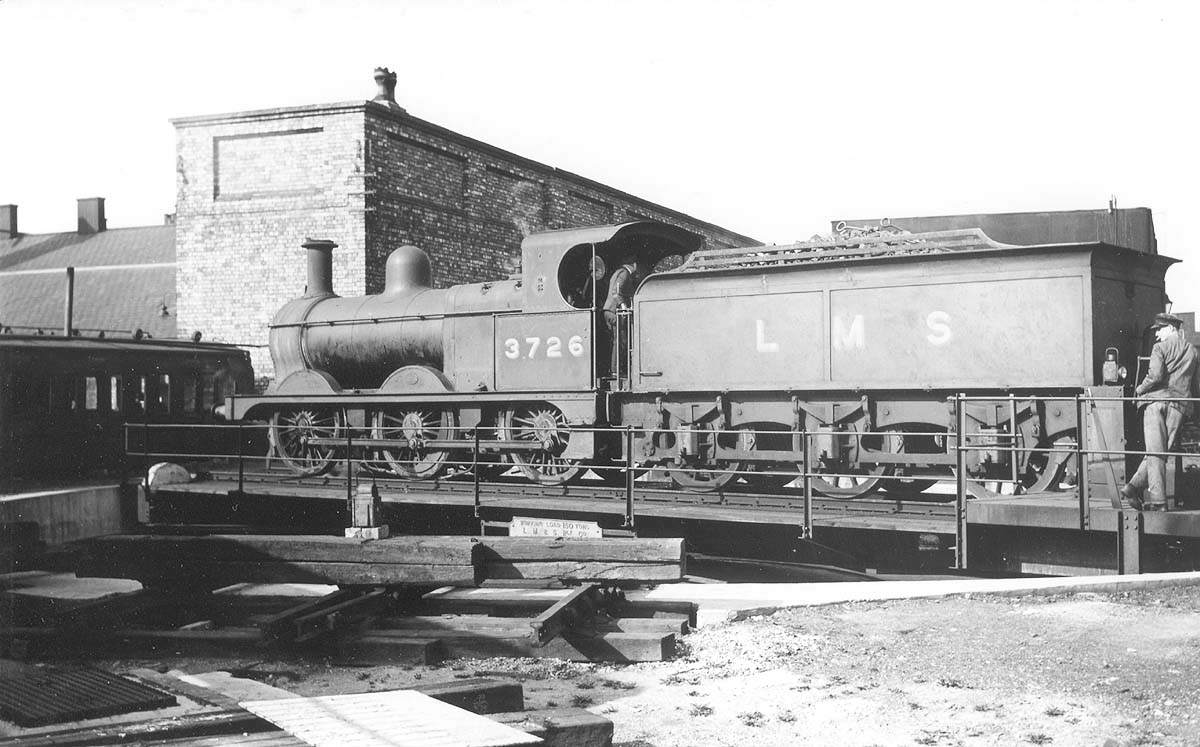 View of an ex-MR 2F 0-6-0, No 3726, standing on the turntable at Milverton shed as its driver operates the vacuum powered table