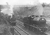 An unidentified ex-MR 3F 0-6-0 locomotive and an LMS 4F 0-6-0 locomotive are being employed on works trains