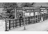 Close up of the distinctive MR Forge Mills station name board and the equally distinctive MR fencing with diagonal slats