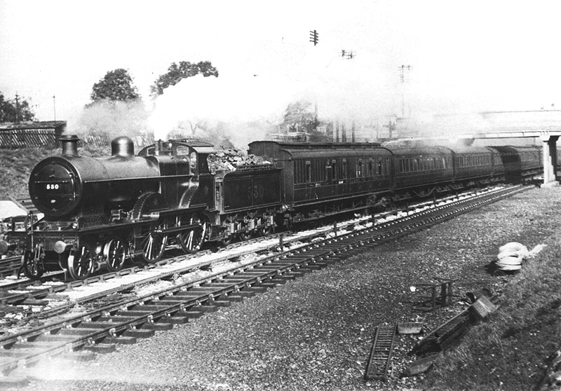 Ex-MR 2P 4-4-0 No 530 is seen moving at speed whilst at the head of a down express during the track widening