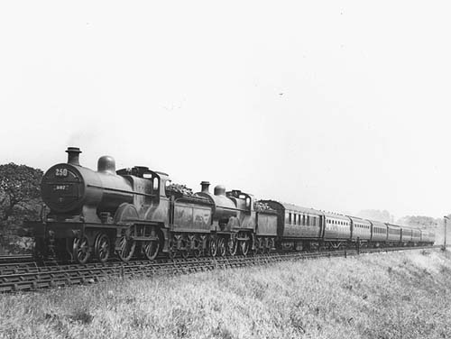 A pair of MR 2P 4-4-0s, Nos 397 and 523 accelerate an eight coach express away from Kings Norton