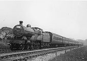 LMS 4-4-0 'Compound' 4P No 1030 is seen at the head of a holiday passenger express during the summer of 1937