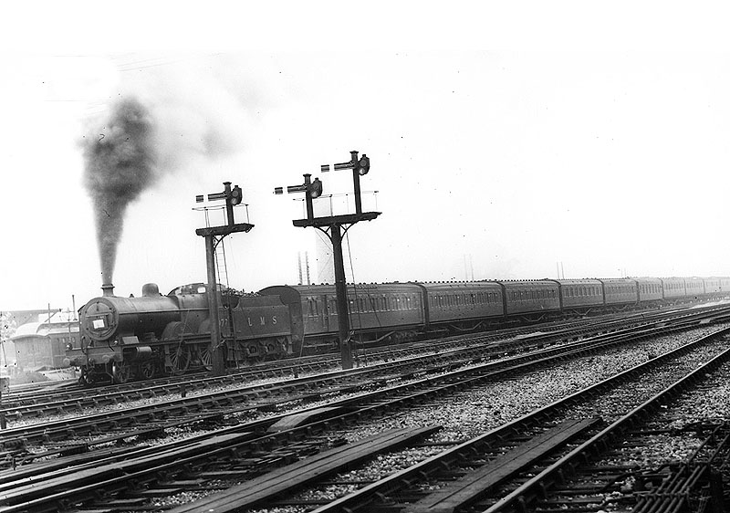 LMS 4-4-0 'Compound' 4P No 1077 is seen working hard as it heads an up empty stock working out of the carriage sidings