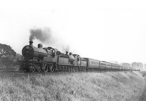 Ex-MR 2P 4-4-0 No 509 doubleheads ex-MR 2P 4-4-0 No 369 on a thirteen or fourteen coach holiday special