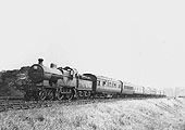 Ex-MR 4-4-0 2P No 511 heads an eight coach holiday excursion passenger express during the summer of 1936