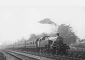 LMS Stanier 2-6-2T 3P No 92 is seen travelling at speed on a seven coach local passenger service in 1937