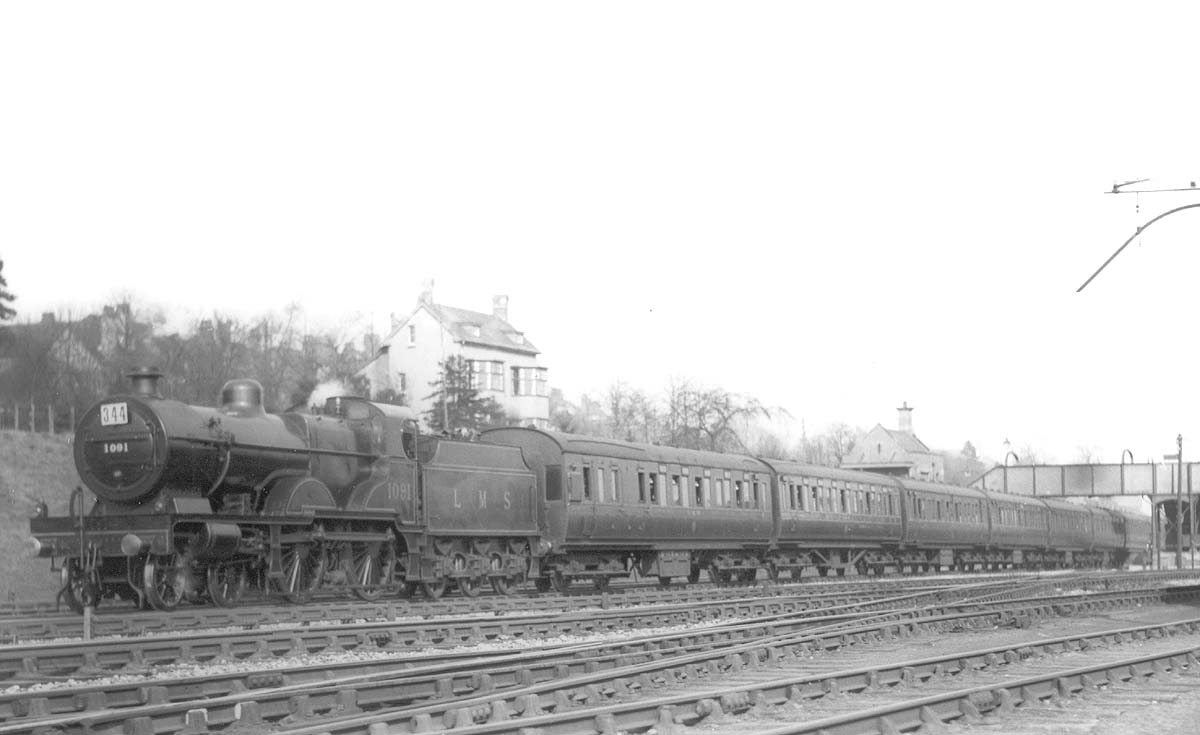 Ex-MR 4-4-0 'Compound' No 1001 heads a down express pasenger service past the carriage sidings in March 1930