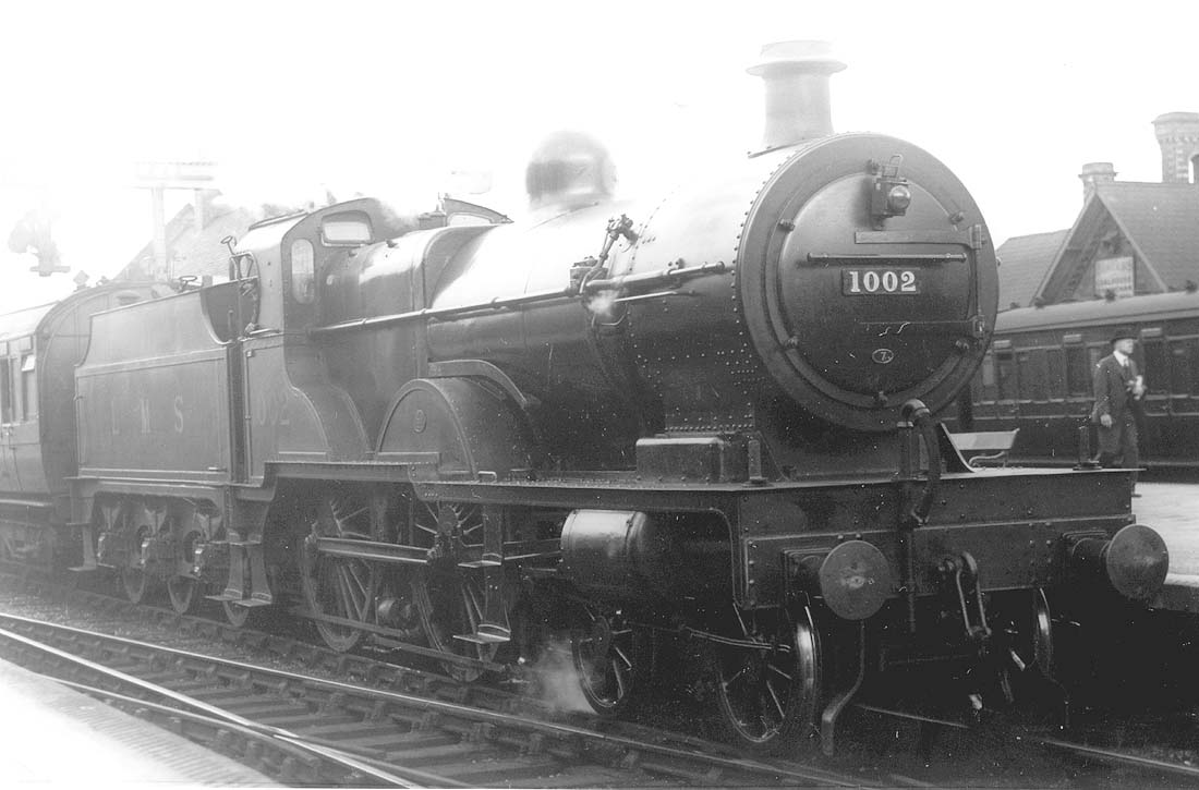 Ex-MR 4-4-0 'Compound' No 1002 stands at Kings Norton station's down West Suburban platform at the head of an empty stock working