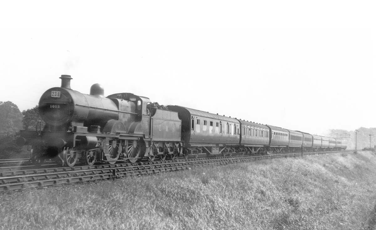 Ex-MR 4-4-0 'Compound' 4P No 1013 heads an express passenger service near Kings Norton during the summer of 1936