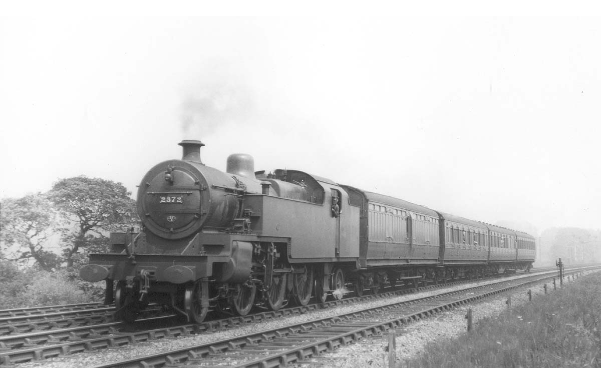 LMS 2-6-4T 4P No 2372 is seen accelerating hard at the head of a four coach local passenger service in 1937