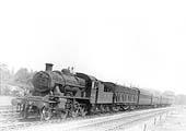 LMS 2-6-0 2MT No 6400 is seen heading a local passenger service made up of mixed coaching stock
